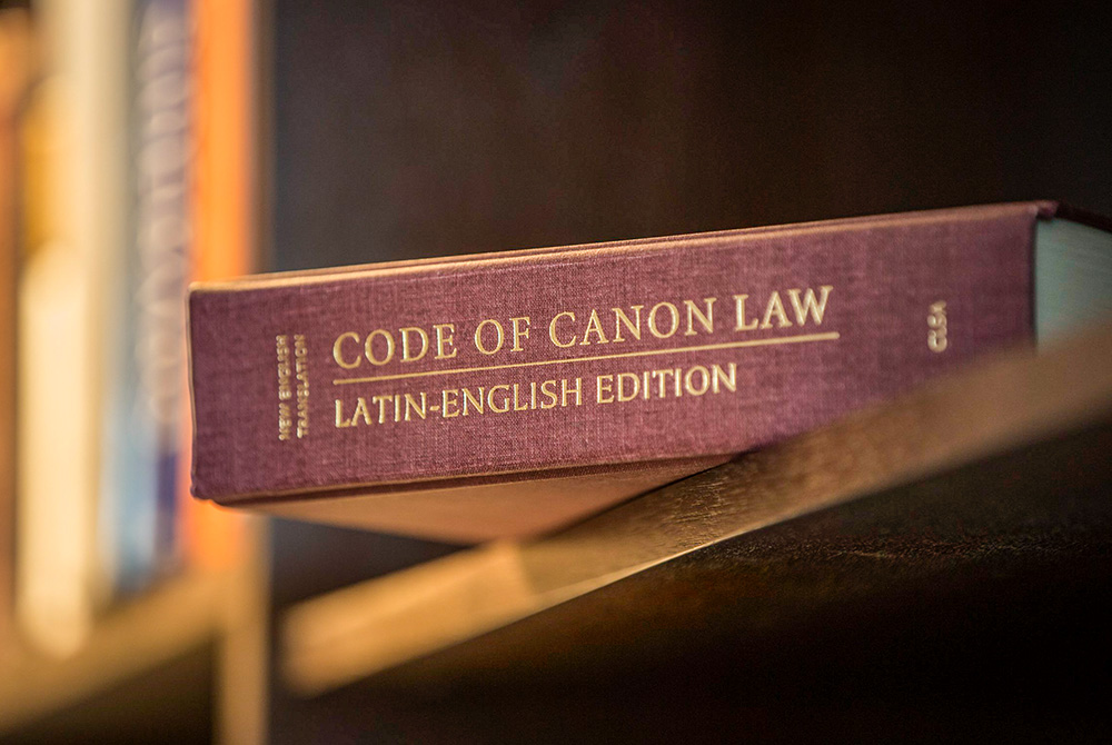 A Latin-English edition of the Code of Canon Law is pictured on a bookshelf. (CNS/Nancy Phelan Wiechec)