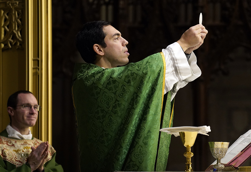 Fr. Luigi Portarulo elevates the host during a vigil Mass for participants in the New York City Marathon at the Basilica of St. Patrick's Old Cathedral in New York City Nov. 2, 2024. Portarulo, parochial vicar at St. Patrick's, was leading a pilgrimage of Italian and Italian Americans en route to Masada at the Dead Sea when emergency alerts began to sound across their mobile phones Feb. 28, 2026. Portarulo spoke to NCR via a WhatsApp interview. (OSV News/Gregory A. Shemitz)