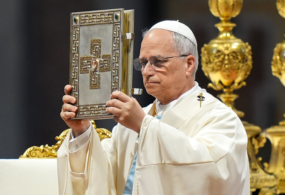 Pope Leo XIV elevates the Book of the Gospels during Mass marking the Jubilee of the Holy See in St. Peter’s Basilica at the Vatican June 9, 2025. (CNS/Lola Gomez)
