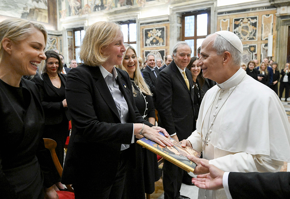 Pope Leo XIV receives children's books about women in science, including Ada Byron Lovelace and the Thinking Machine, during an audience with participants in a conference, "The Dignity of Children and Adolescents in the Age of Artificial Intelligence," in the Apostolic Palace at the Vatican Nov. 13, 2025. (CNS/Vatican Media)