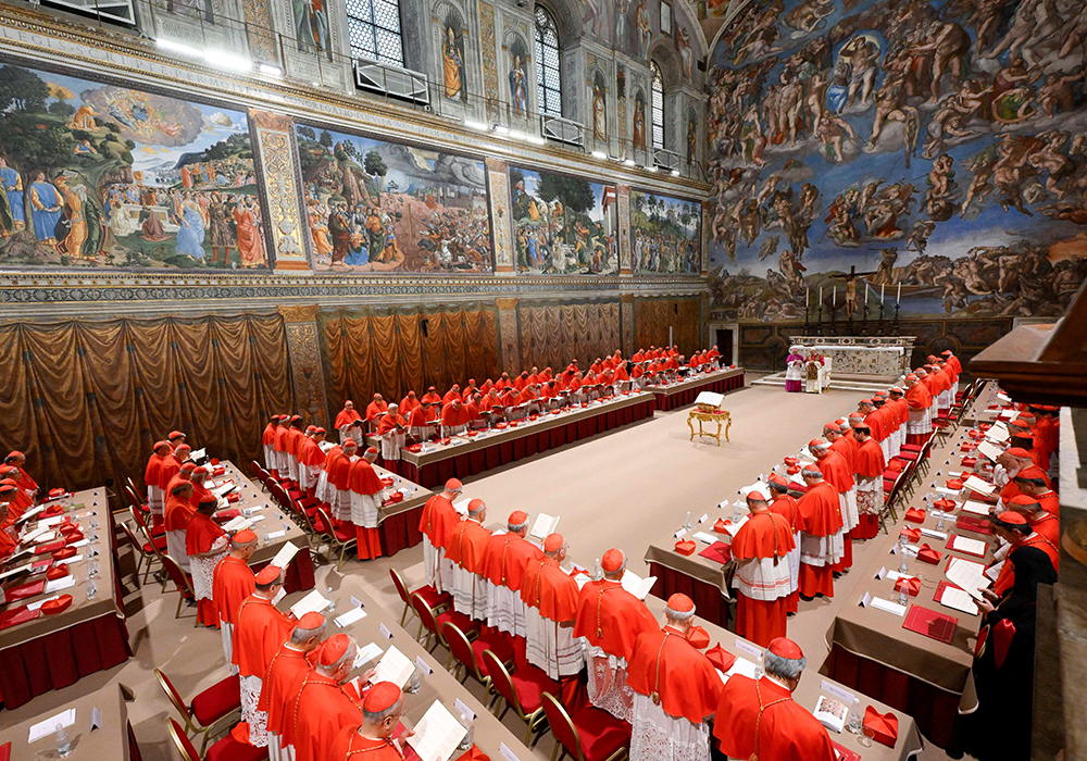 Pope Leo XIV, right, stands in the Sistine Chapel among cardinals after being elected at the Vatican, May 8, 2025. He became the first American pope in history. (OSV News/Vatican Media via Reuters/Francesco Sforza)