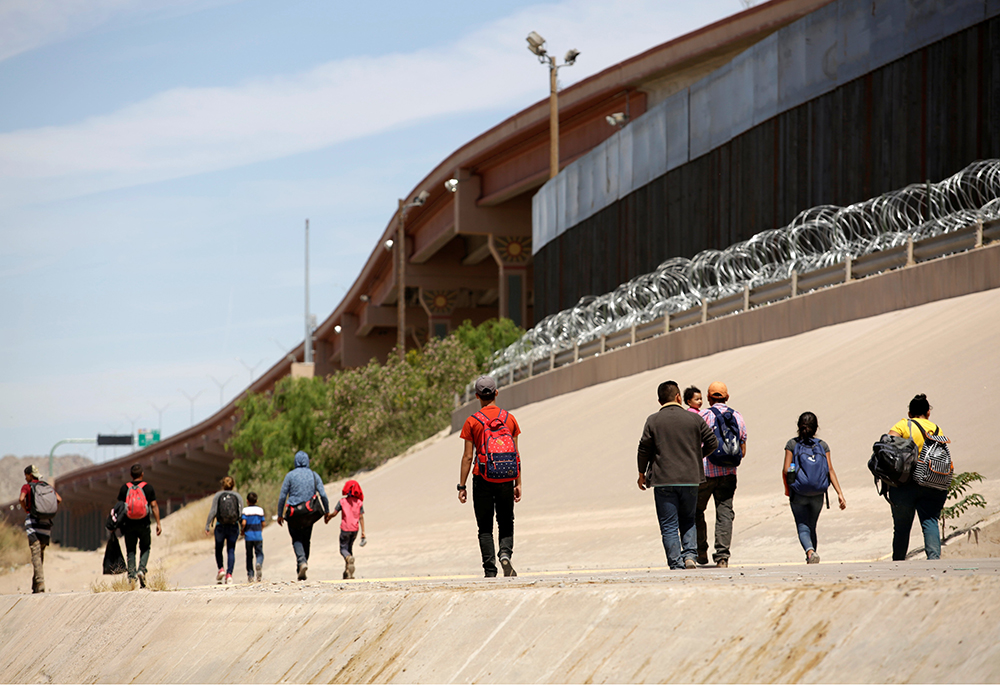 Migrants walk after crossing the Bravo River at the border line between Ciudad Juarez, Mexico, and El Paso in Texas, U.S., as seen from Ciudad Juarez, May 9, 2019. (CNS/Reuters/Jose Luis Gonzalez)
