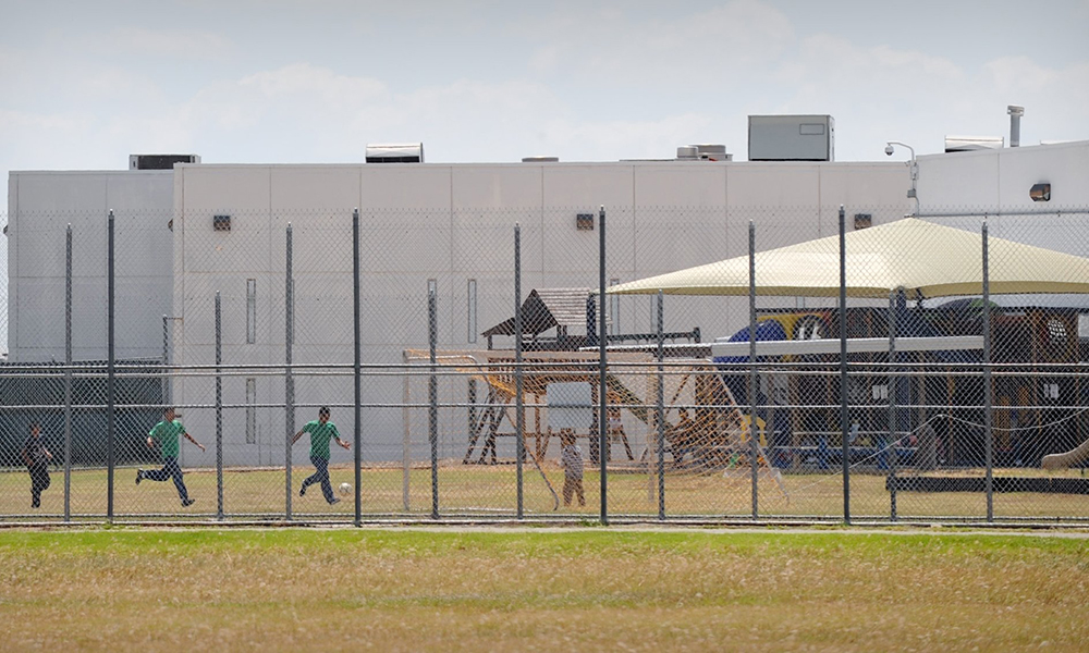 Children are pictured in a file photo playing in a double-fenced playground area outside the T. Don Hutto Family Residential Facility in Taylor, Texas. (OSV News/Bahram Mark Sobhani)