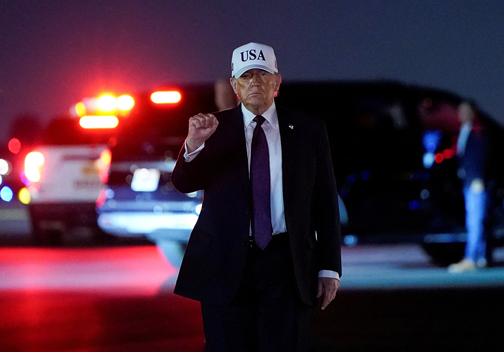 U.S. President Donald Trump pumps his fist after disembarking Air Force One at Palm Beach International Airport in West Palm Beach, Florida, Feb. 27, 2026. (OSV News/Reuters/Elizabeth Frantz)