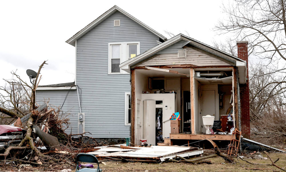 Debris surrounds a damaged home in Three Rivers, Mich., March 7, 2026, following storms and tornado warnings. Powerful storms tore through parts of Michigan and Oklahoma, leaving a trail of destruction that included flattened homes and scattered debris. Volunteers helped residents sift through rubble and begin cleanup as the threat of severe weather lingered across the nation's midsection. (OSV News photo/Rebecca Cook, Reuters)