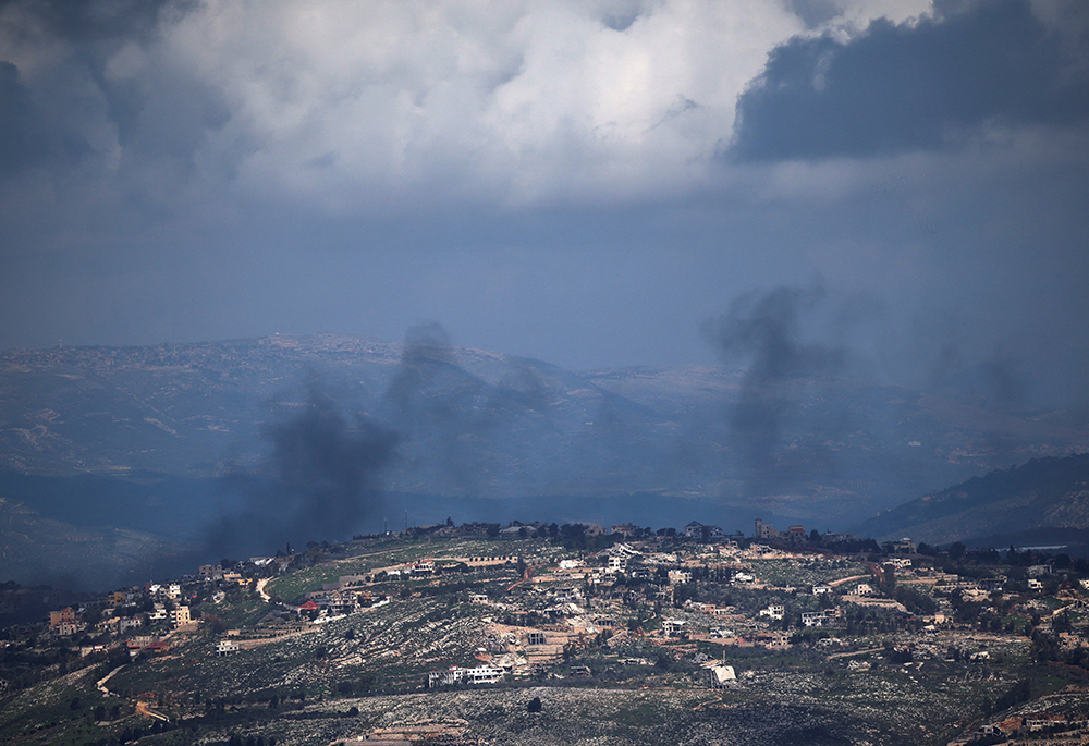 Smoke rises from a village in Lebanon as seen from northern Israel, March 16, 2026, following an Israeli airstrike, amid escalation in aerial attacks between Hezbollah and Israel as the U.S.-Israel war with Iran continues. (OSV News/Reuters/Shir Torem)