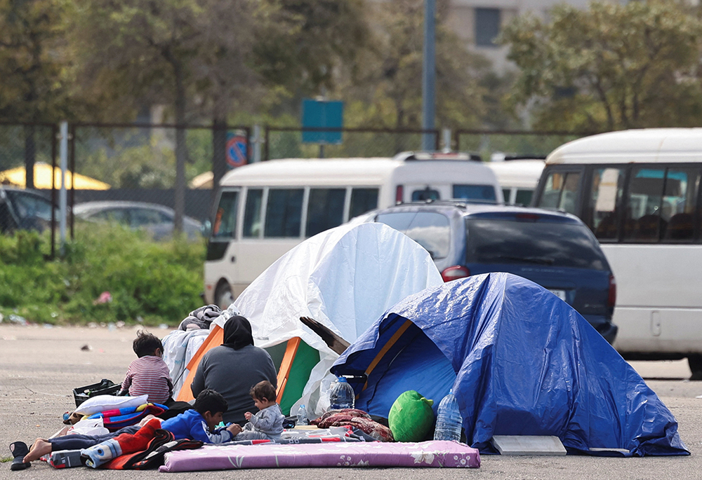 Displaced people with belongings sit next to tents in Beirut March 16, 2026, following an escalation of aerial attacks between Hezbollah and Israel, amid the U.S. and Israel-Iran war. (OSV News/Reuters/Amr Abdallah Dalsh)