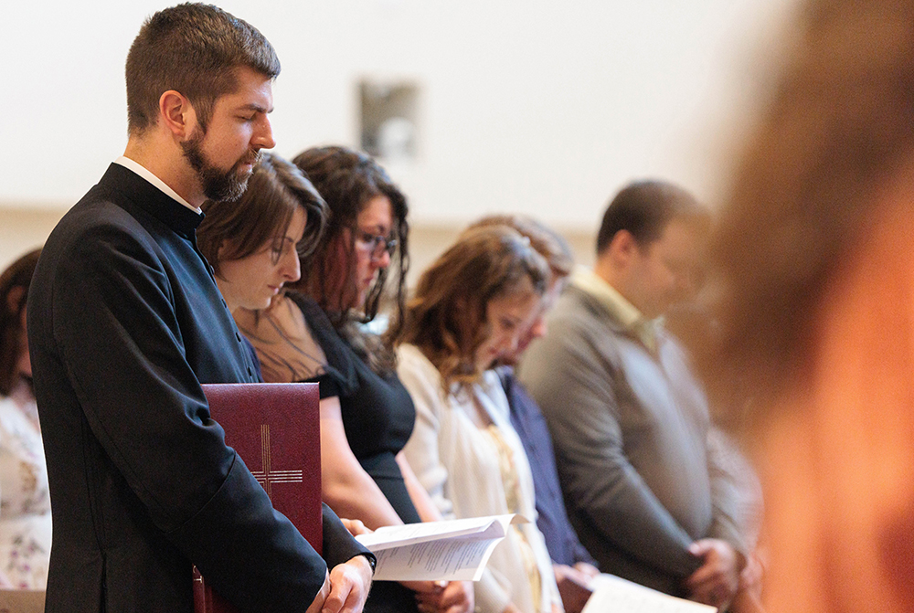 Fr. Christopher Masla holds the Book of the Elect at the Diocese of Richmond's Rite of Election at Our Lady of Nazareth Church in Roanoke, Va., March 1, 2026. In a record for the Diocese of Richmond, 900 people will be baptized, receive the Eucharist, and be confirmed in the Catholic Church at Easter Vigil Masses April 4. (OSV News/Diocese of Richmond/Ryan Hunt)