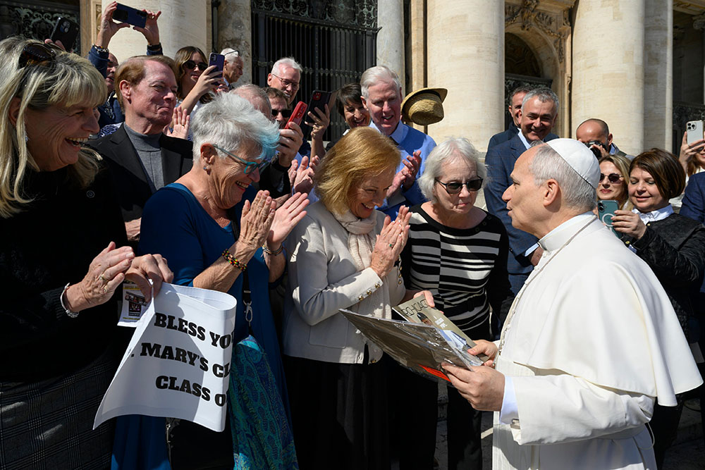 Pope Leo XIV meets with former classmates who graduated from the lower school of St. Mary of the Assumption in Chicago in 1969 after the general audience in St. Peter's Square at the Vatican March 18, 2026. (CNS/Vatican Media)