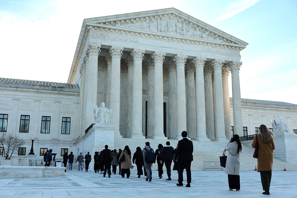 Visitors enter the U.S. Supreme Court building in Washington March 24, 2026. That day, a small group of clergy gathered for a vigil prior to arguments in Noem v. Al Otro Lado, a case to determine if noncitizens blocked on the Mexican side of the border by U.S. officials can apply for asylum. (OSV News/Reuters/Jonathan Ernst)