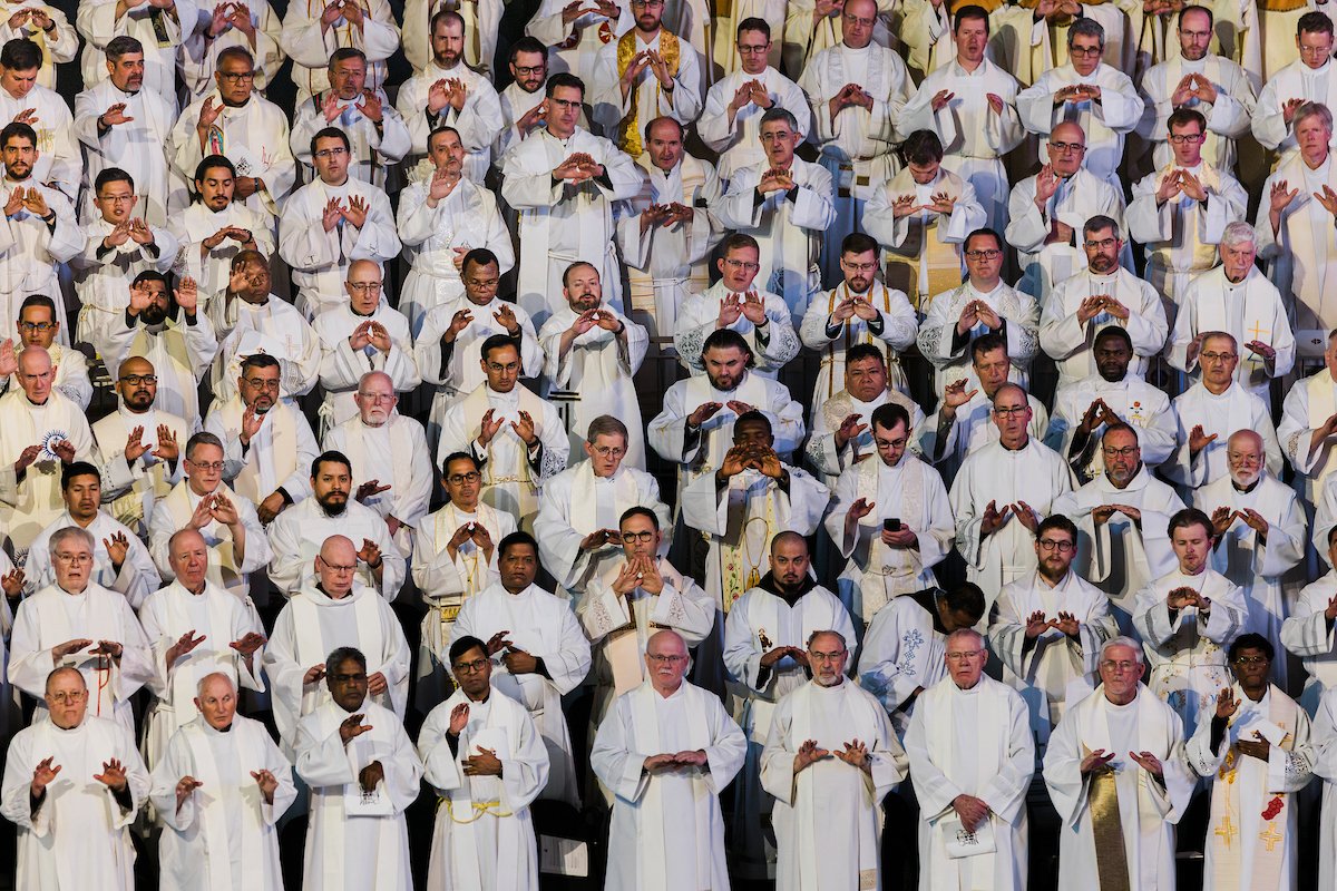 Clergymen pray as Denver Archbishop James R. Golka celebrates his installation Mass in CoBank Arena at the National Western Complex in Denver March 25, 2026. Archbishop Golka was previously bishop of Colorado Springs, and in Denver he succeeds Archbishop Samuel J. Aquila. (OSV News photo/Grant Whitty, Denver Catholic)