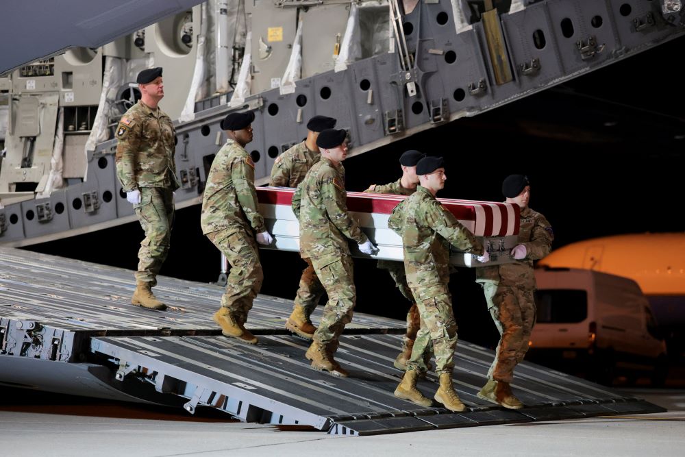 Members of the military carry a transfer case during the dignified transfer of the remains of U.S. Army Sgt. Benjamin Pennington at Dover Air Force Base in Delaware March 9. Pennington died on March 8 from injuries sustained during a March 1 attack at Prince Sultan Air Base in Saudi Arabia. The U.S. military says 13 U.S. service members have died in the U.S.-Israeli war with Iran. (OSV News/Kylie Cooper)