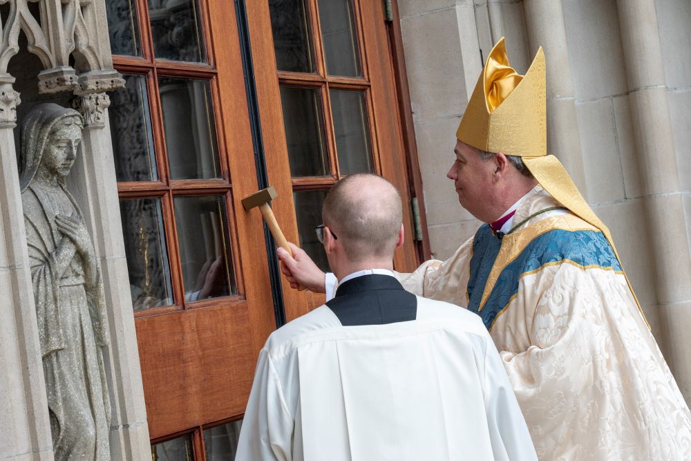 Bishop John Bonnici knocks on the door of the cathedral ahead of his installation Mass as the 10th bishop of Rochester, N.Y., at Sacred Heart Cathedral in Rochester March 19, 2026. He was previously an auxiliary bishop in New York. (OSV News/Jeff Witherow, Catholic Courier)
