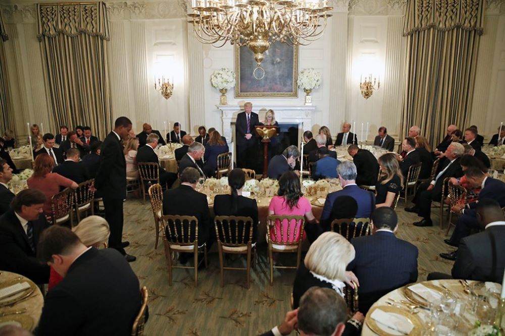 President Donald Trump bows his head as pastor Paula White-Cain leads the room in prayer during a dinner for evangelical leaders in the State Dining Room of the White House on Aug. 27, 2018, in Washington. (AP/Alex Brandon)