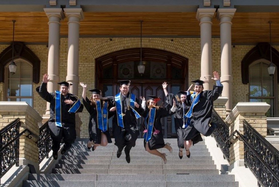 Graduates celebrate on the steps of the main building at the University of Notre Dame following their May 15, 2016, commencement ceremony in Indiana. (CNS/University of Notre Dame/Barbara Johnston)