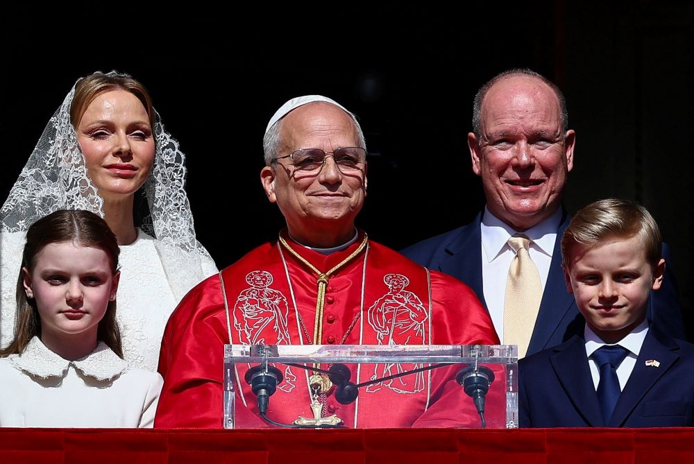 Pope Leo XIV greets the public with Prince Albert II of Monaco, Princess Charlene, Prince Jacques and Princess Gabriella at the Prince's Palace in Monaco-Ville, Monaco, March 28, during his second apostolic journey. The palace's state apartments were created in the 16th century and later remodeled on that of those at Versailles. (CNS/Lola Gomez)