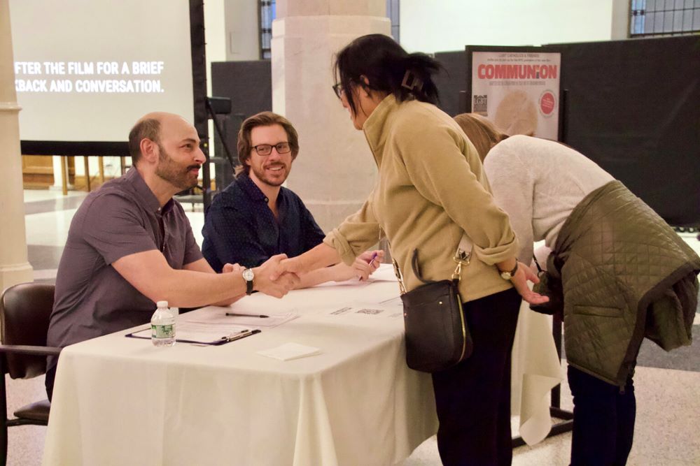 Matthew LaBanca, left, and husband Rowan greet attendees for a screening of the film "Communion" March 26 at St. Ignatius Loyola on Park Avenue on Manhattan's Upper East Side. (RNS/Fiona Murphy)