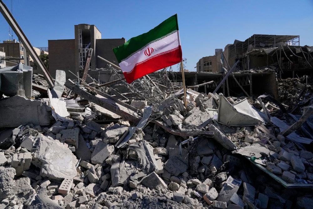 An Iranian flag is placed among the ruins of a police station struck March 2 during the U.S.-Israeli military campaign in Tehran, Iran, March 3. (AP/Vahid Salemi)