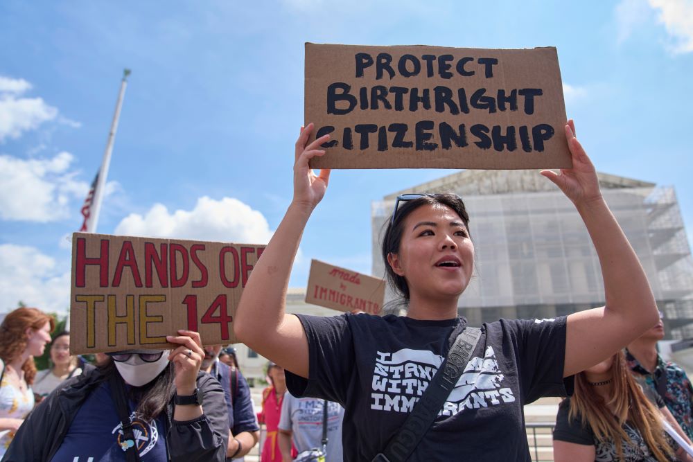 Hannah Liu, 26, of Washington, holds up a sign in support of birthright citizenship, May 15, 2025, outside the Supreme Court in Washington, D.C. (AP/Jacquelyn Martin)