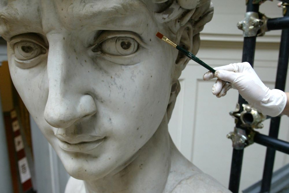 Italian restorer Cinzia Parnigoni cleans Michelangelo's David at the Galleria dell'Accademia in Florence, Italy, Sept. 15, 2003. The renowned work was undergoing a cleaning for the first time since the massive statue was relocated to the gallery in 1873. (CNS/Reuters)