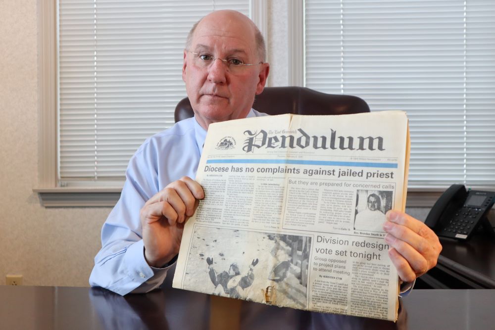 Dr. Herbert "Hub" Brennan, a clergy abuse survivor, displays a 1995 newspaper showing a headline that reads "Diocese has no complaints about jailed priest" at his internal medicine office in East Greenwich, R.I., March 5. (AP/Leah Willingham)