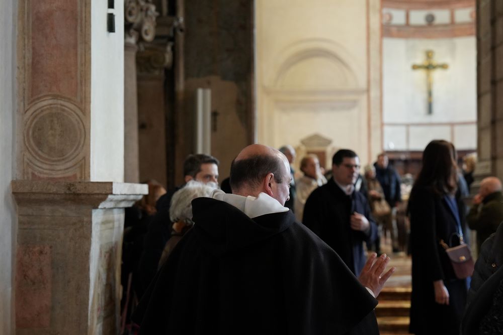 Dominican Fr. Llewellyn Muscat speaks with visitors in the Basilica of Santa Maria delle Grazie, best known as the home of Leonardo da Vinci's "The Last Supper," in Milan, Italy, Feb. 15, 2026. (AP/María Teresa Hernández)