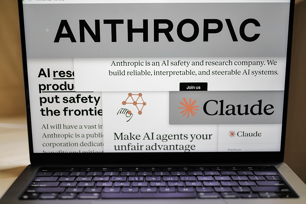 Pages from the Anthropic website and the company's logos are displayed on a computer screen in New York on Feb. 26, 2026. (AP/Patrick Sison)