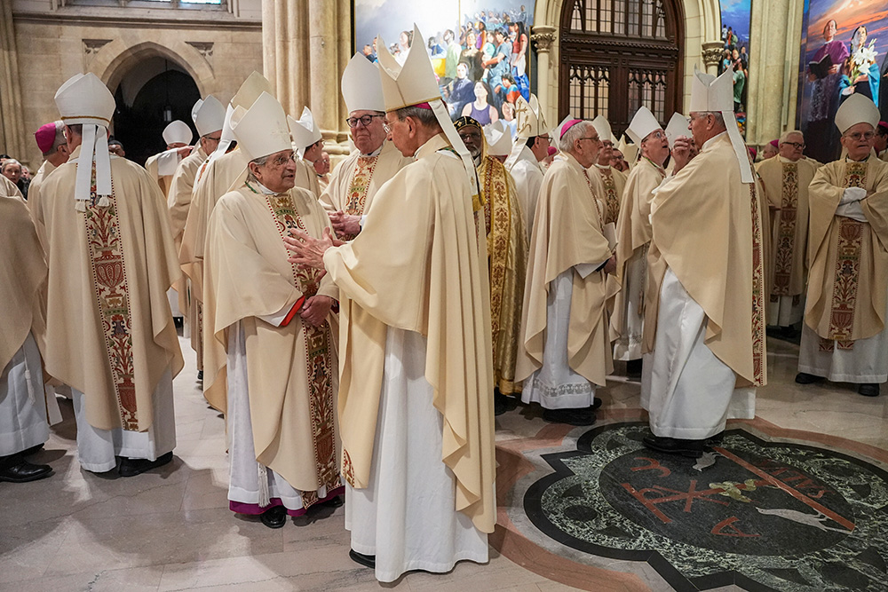 Bishops talk as they gather for the procession during the Installation Mass for New York Archbishop Ronald Hicks at St. Patrick's Cathedral in the Manhattan borough of New York on Feb. 6, 2026. (Pool Reuters via AP/Angelina Katsanis)