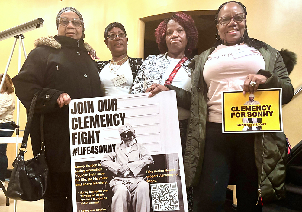 Eddie Mae Ellison, Jackie Bradford, Mary Bradford and Lois Harris hold signs urging Alabama Gov. Kay Ivey to grant clemency for their family member Charles "Sonny" Burton, Jan. 28, 2026 in Montgomery, Alabama. (AP photo/Kim Chandler)