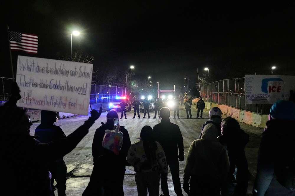 Federal immigration officers confront protesters outside Bishop Henry Whipple Federal Building in Minneapolis, on Jan. 15, 2026. (AP Photo/Yuki Iwamura, File)