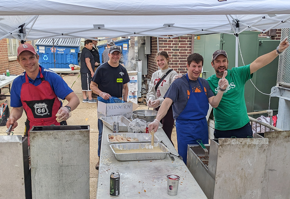 A team of parishioners cook fish at the annual Lenten fish fry at St. Margaret of Scotland Catholic Church, in St. Louis, March 31, 2023. This year, with the help of a grant from the St. Louis Archdiocese's Laudato Si' Commission, the parish for the first time will compost leftover food and compostable materials in an effort to reduce waste. (St. Margaret of Scotland Catholic Church)