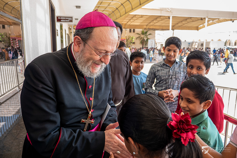 Bishop Paolo Martinelli, apostolic vicar of Southern Arabia, greets children during a pastoral visit in February 2026. (Courtesy of Apostolic Vicariate of Southern Arabia)