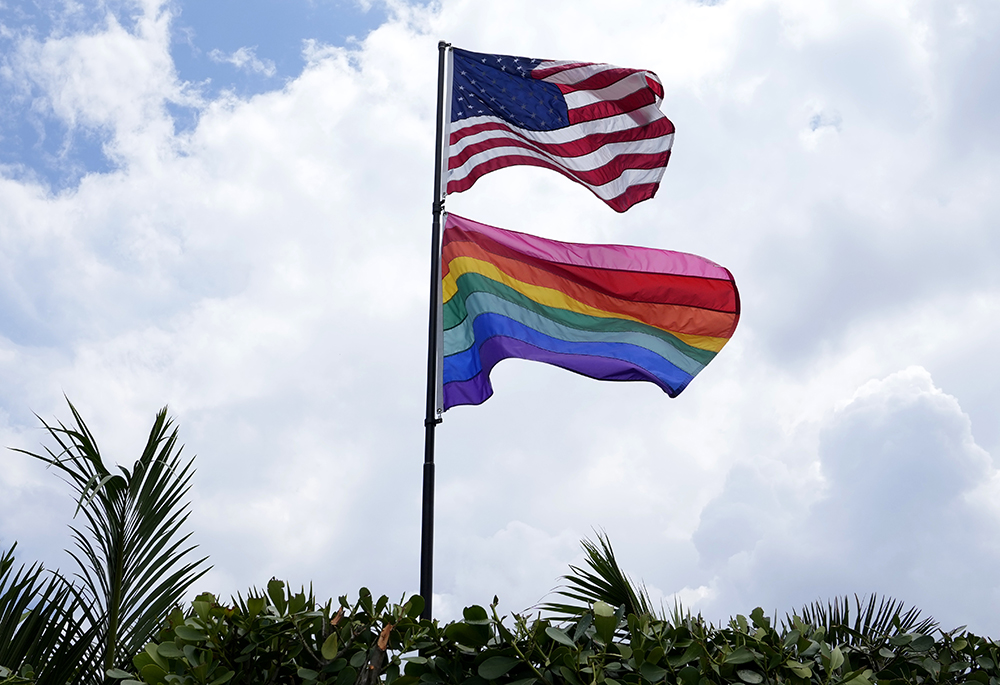 An American flag flies with a pride flag outside of a home in Wilton Manors, Fla., Thursday, June 29, 2023. (AP photo/Lynne Sladky)