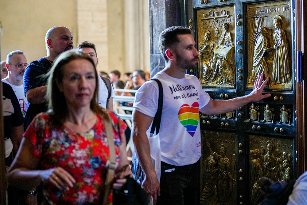 Some of the hundreds of LGBTQ+ Catholics and their families who joined a Holy Year pilgrimage to Rome walk through the Holy Door of St. Peter's Basilica at the Vatican Sept. 6, 2025. (AP/Andrew Medichini)