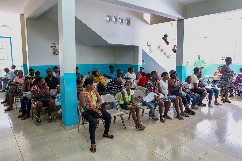 People sit in the waiting area of the outpatient clinic at St. Francis de Sales Hospital in Port-au-Prince, Haiti, Feb. 16, 2015. (CNS/Bob Roller)