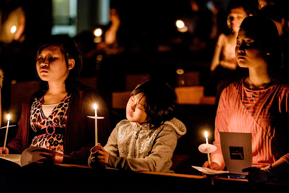 Young people hold candles during the Easter Vigil at the Cathedral of St. Joseph in Hartford, Conn., in 2015. (CNS/Bob Mullen)