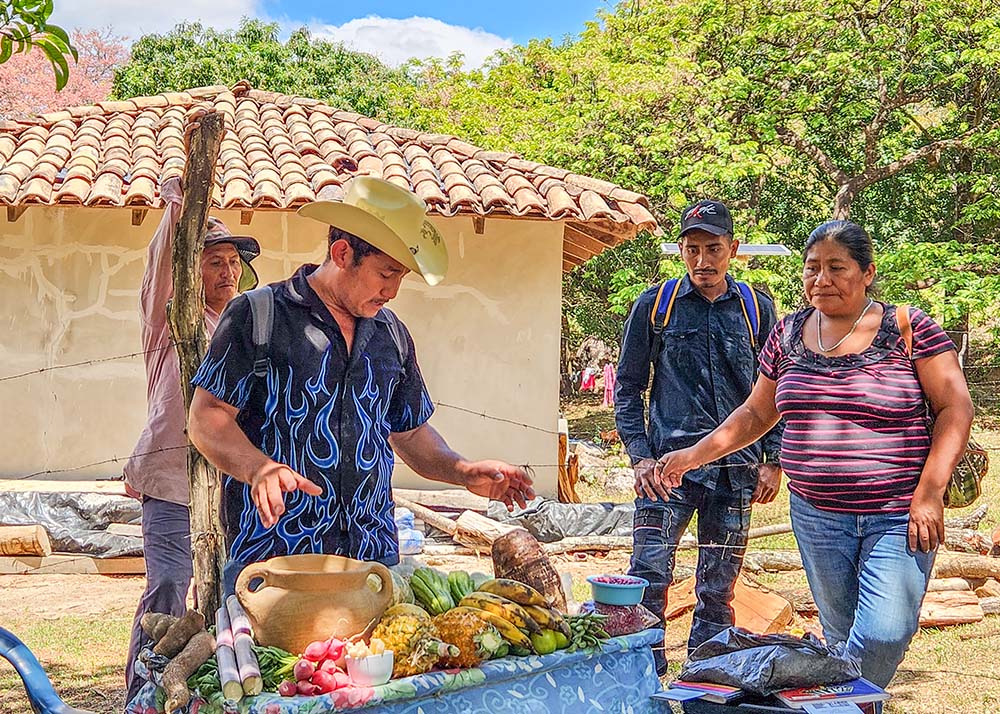Desiderio Vasquez, a local farmer, shows off a colorful cornucopia of the bounty cultivated and grown partly through a series of irrigation systems the community of Los Hornos, Honduras, built with the help of Catholic Relief Services and local partners. (NCR photo/Brian Roewe)