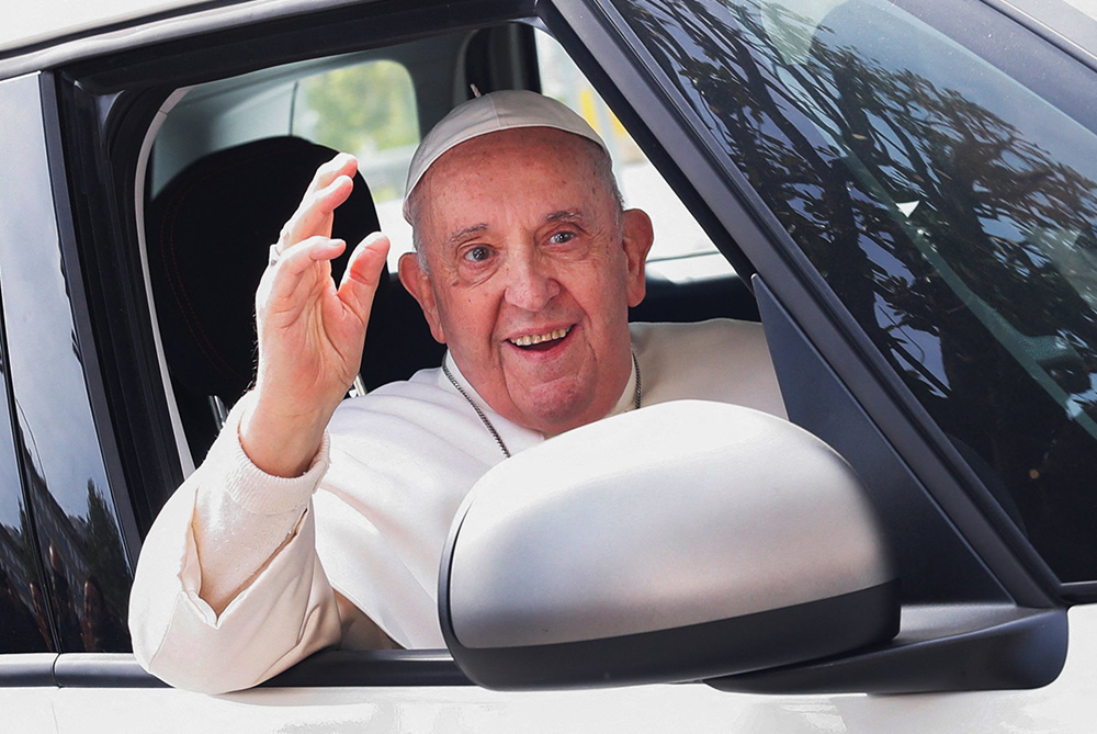 Pope Francis waves from a car as he leaves Rome's Gemelli hospital April 1, 2023. He had been hospitalized for treatment of bronchitis. (OSV News/Reuters/Remo Casilli)