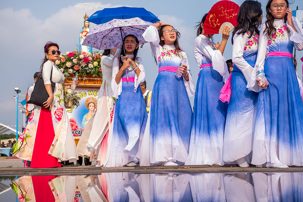 Vietnamese Catholics participate in a Marian procession at Our Lady of Lavang Catholic Church in Houston during a festival May 6, 2023. Hundreds of Catholics joined the procession, some escorting floats carrying statues of the Holy Family, the Divine Mercy Jesus and the Blessed Virgin Mary while praying the rosary. (OSV News/Texas Catholic Herald/James Ramos)