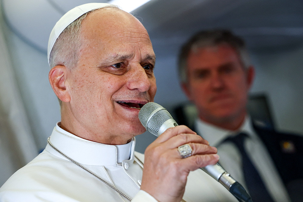 Pope Leo XIV speaks to members of the media aboard the papal plane April 15, 2026, en route to Yaoundé, Cameroon, amid his apostolic journey. (OSV News/Guglielmo Mangiapane, pool)