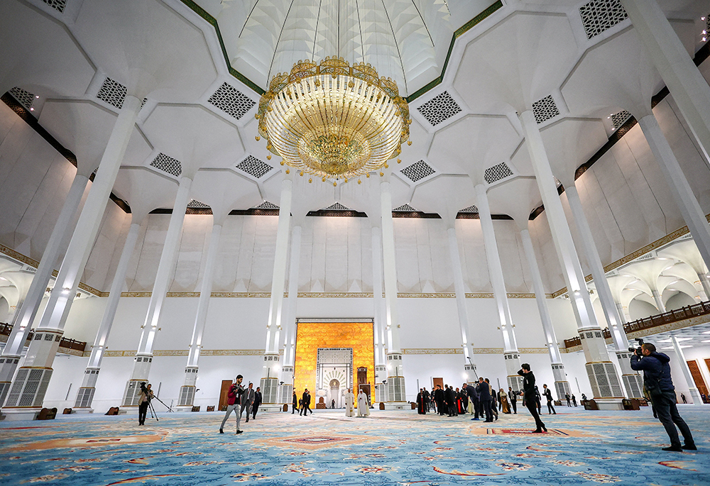 Pope Leo XIV walks with Mohamed Mamoun Al Qasimi, rector of the Great Mosque of Algiers in Algiers, Algeria, April 13, 2026. The pontiff visited the mosque, one of the largest in the world, in a gesture aimed at reinforcing Christian-Muslim dialogue. (OSV News/Reuters/Guglielmo Mangiapane)