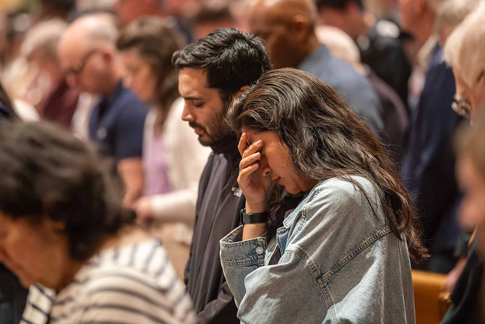 People mark a moment of silence to pray for peace during a vigil Mass for peace celebrated by Washington Cardinal Robert McElroy at the Cathedral of St. Matthew the Apostle in Washington April 11, 2026. Pope Leo XIV had encouraged Catholics around the world to participate in a vigil for peace on that day. (OSV News/Catholic Standard/Mihoko Owada)