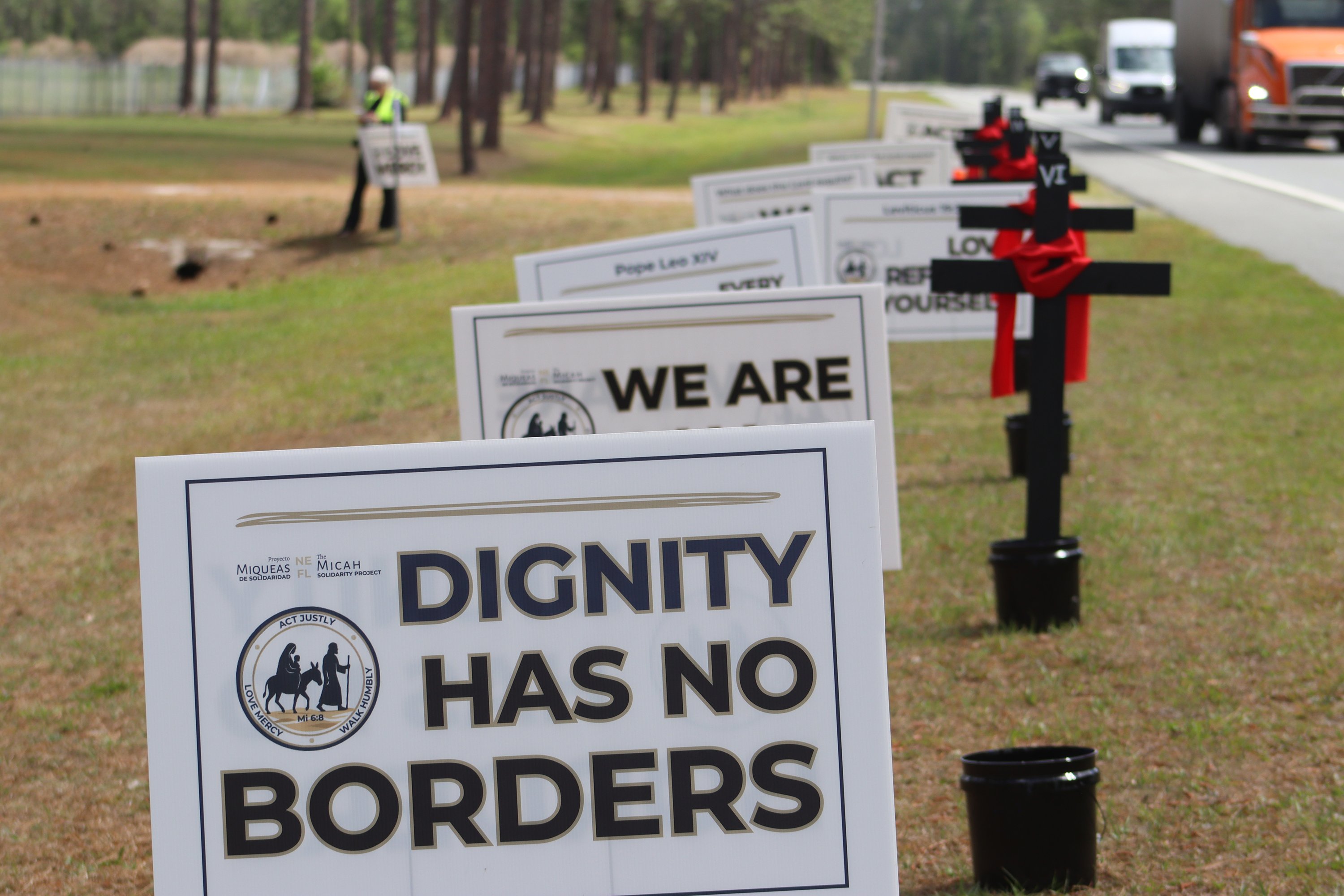 For a reflection on the Stations of the Cross reflection April 3, 2026, crosses mark each of the 14 stations on the side of Highway 90 in north Florida. More than four dozen advocates participated in the reflection an then walked across the street from Deportation Depot, the former Baker Correctional Institution used to house immigrant detainees. 