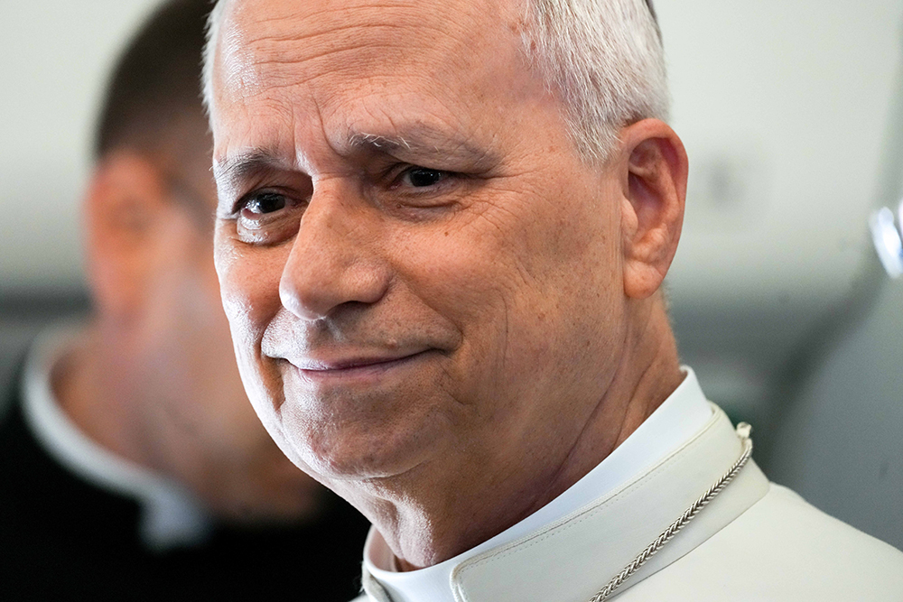 Pope Leo XIV takes a moment to speak with journalists aboard the papal flight from Angola to Equatorial Guinea April 21, 2026. Leo paused to honor his predecessor on the first anniversary of Pope Francis' death, remembering the Argentine pope's witness to mercy and closeness to the poor. (CNS/Lola Gomez)