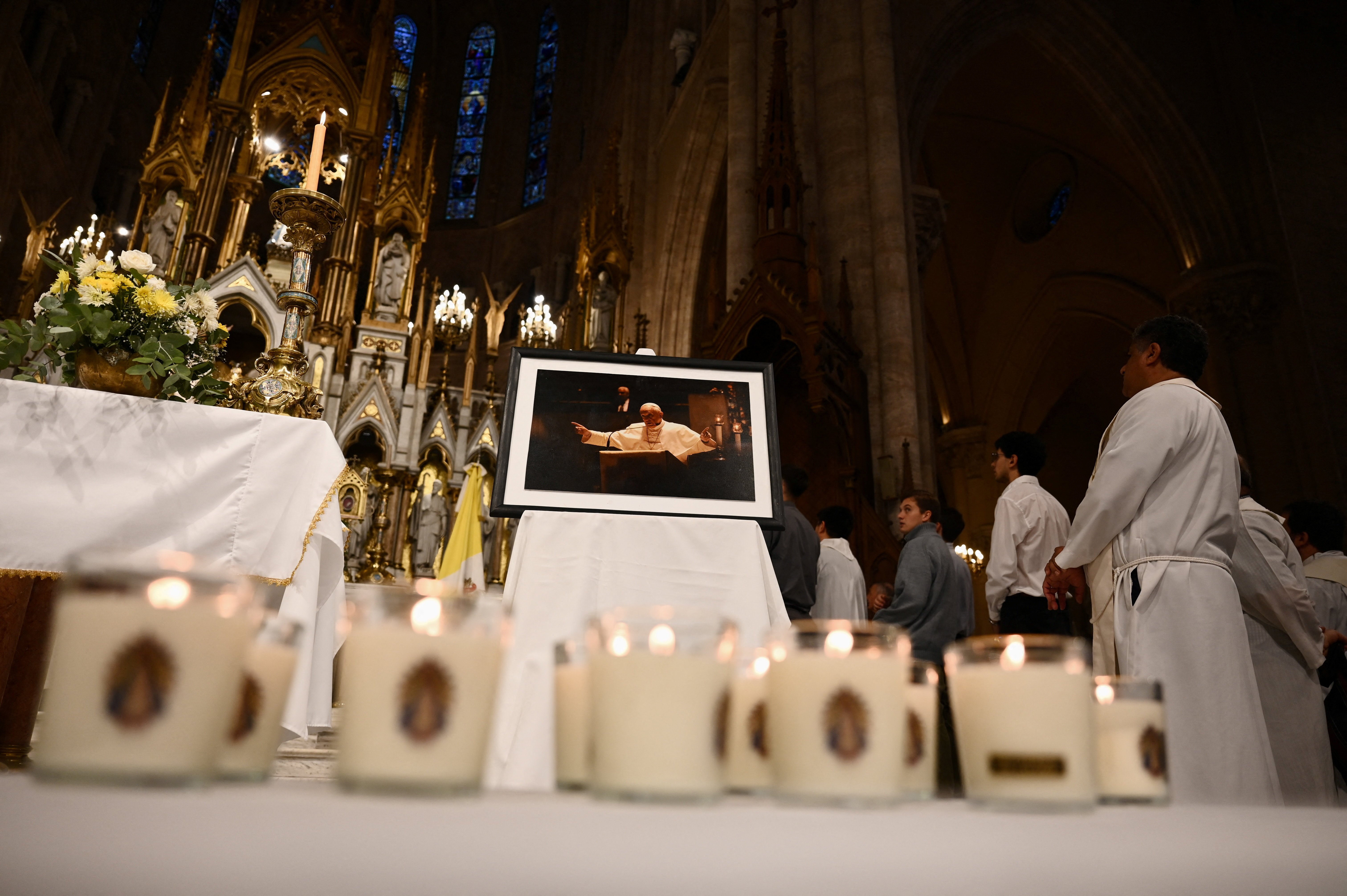 Lit candles lie in front of a portrait of Pope Francis at the Basilica of Lujan in Argentina April 21, 2026, in honor of the pontiff on the first anniversary of his death. Pope Francis, formerly Argentine Cardinal Jorge Mario Bergoglio, died April 21, 2025, at age 88. 