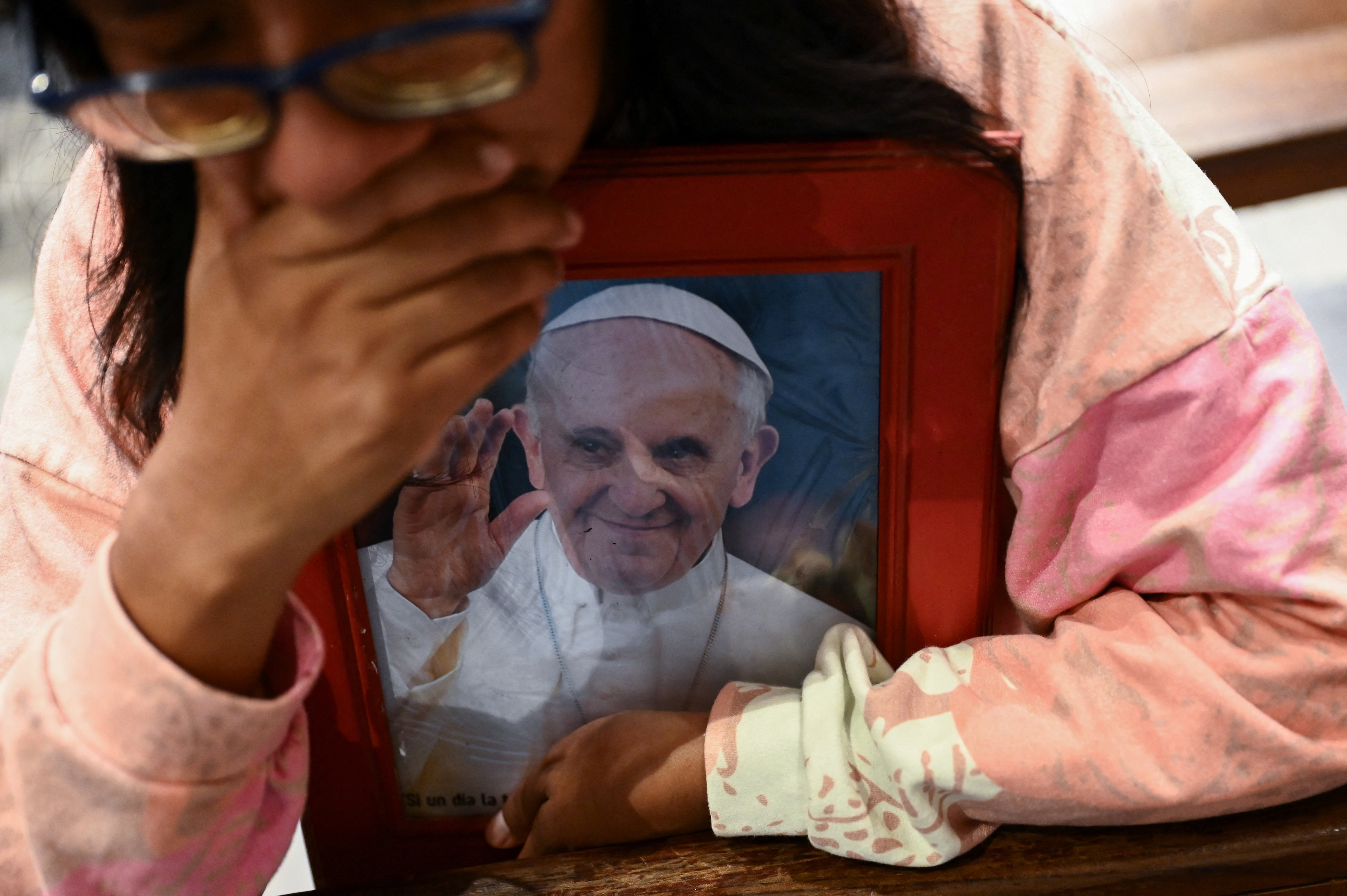 A woman clutches a portrait of Pope Francis during a Mass at the Basilica of Lujan in Argentina April 21, 2026, in honor of the pontiff on the first anniversary of his death. Pope Francis, formerly Argentine Cardinal Jorge Mario Bergoglio, died April 21, 2025, at age 88.