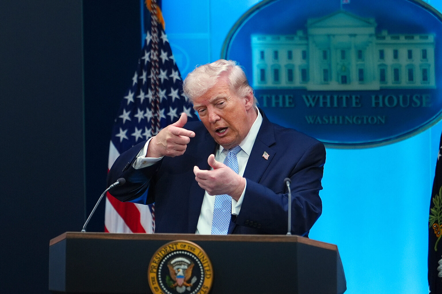 President Donald Trump pretends to aim a sniper gun while speaking with reporters in the James Brady Press Briefing Room at the White House, April 6, 2026, in Washington. 