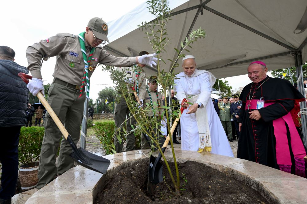 Pope Leo XIV is assisted by a Boy Scout as he visits the archaeological site of Hippo Regius in Annaba, Algeria, April 14, 2026. He planted an olive tree, a sign of peace, at the site. (OSV News/Vatican Media/Simone Risoluti)