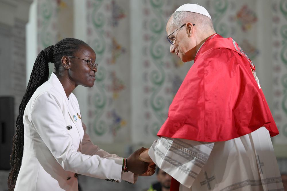 Pope Leo XIV greets a young woman as he attends a meeting with the Algerian community at the Basilica of Our Lady of Africa in Algiers, Algeria, April 13, 2026. Catholics are a significant minority in Muslim-majority Algeria. (OSV News/Vatican Media/Simone Risolutie)