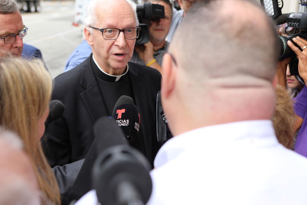 Msgr. Ron Lengwin, vicar for church relations for the Diocese of Pittsburgh, speaks with abuse victim Jim VanSickle of Pittsburgh during an Aug. 20, 2018, news conference held by members of the Survivors Network of those Abused by Priests (SNAP) in front of the diocese's building. (CNS/Chaz Muth)